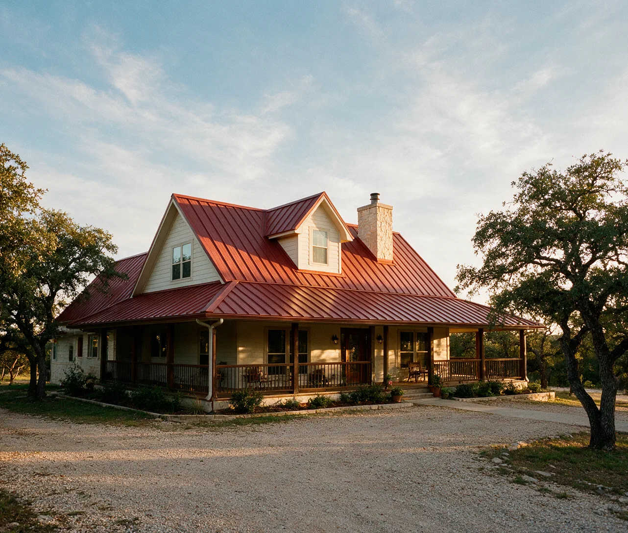 A barn-red ribbed metal roof on a country home